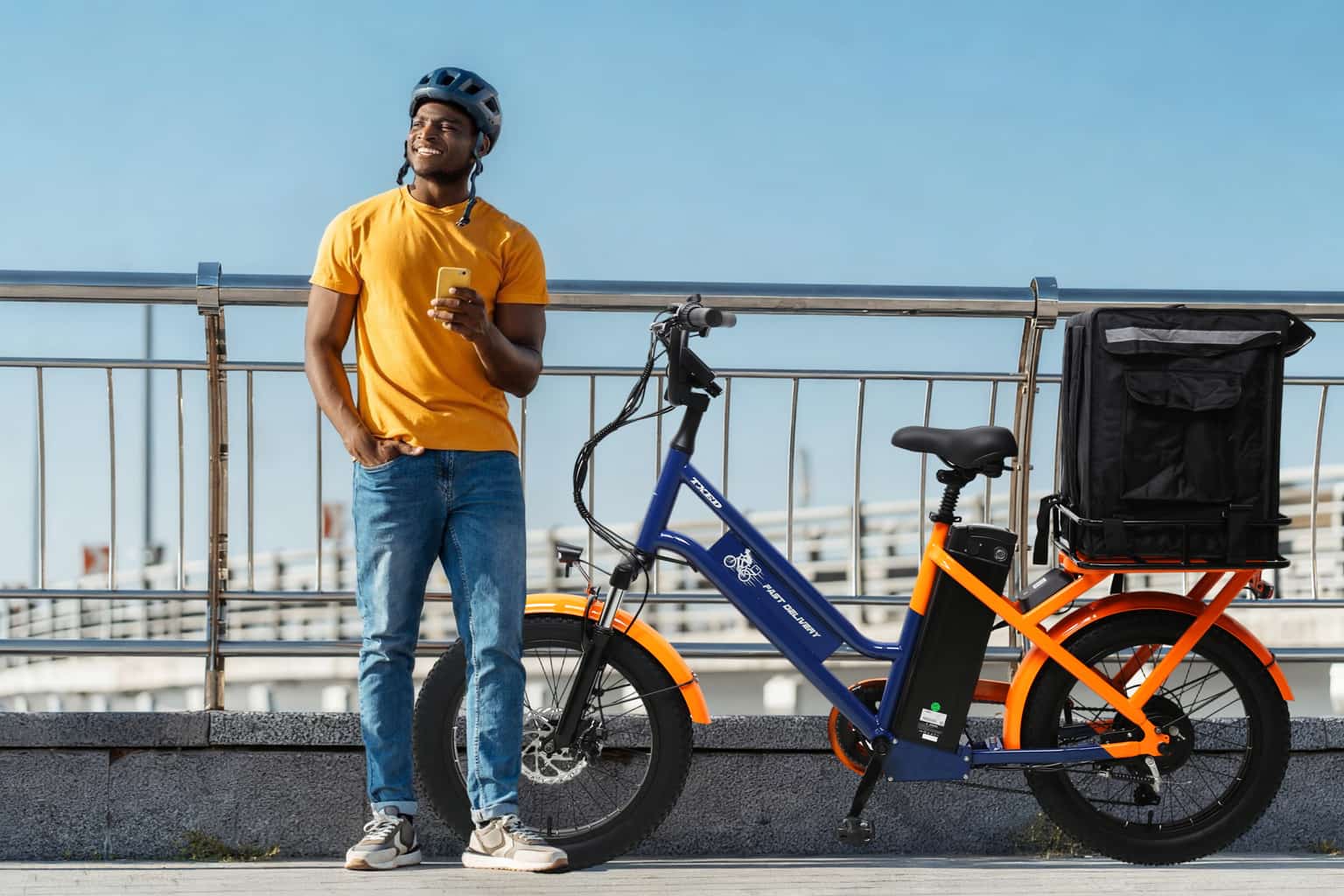 Courier riding a TXED cargo bike through the city