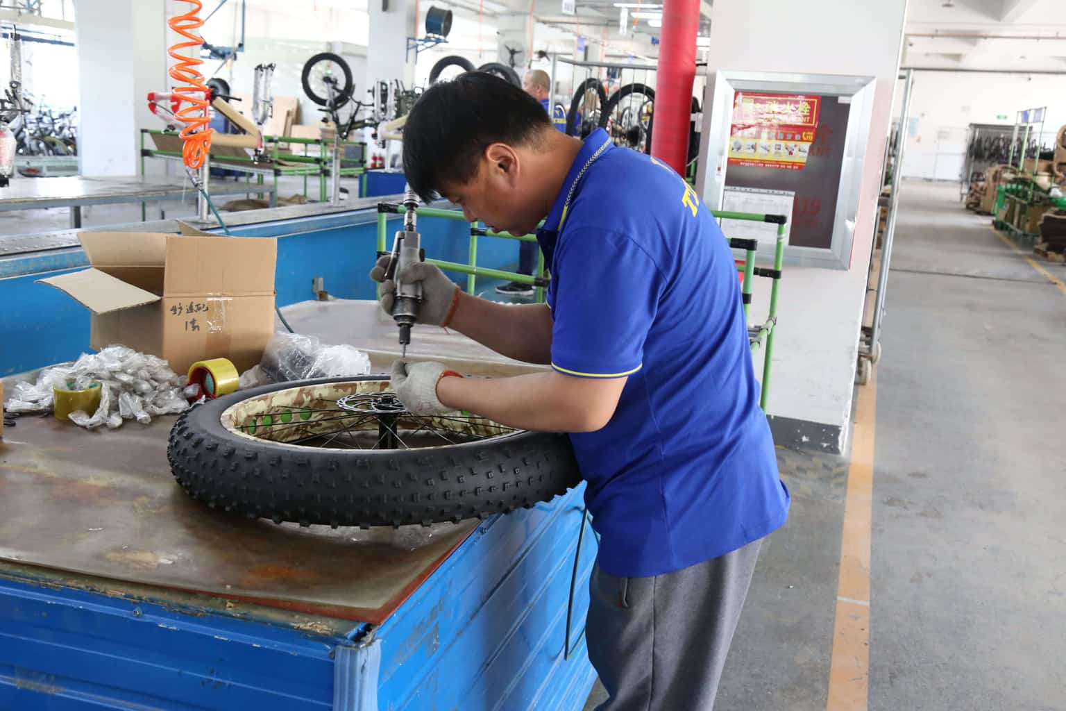 Automated robotic arm welding an e-bike frame