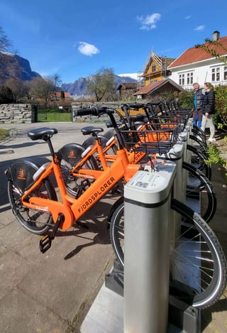 A person using a Txed shared electric bike on a city street