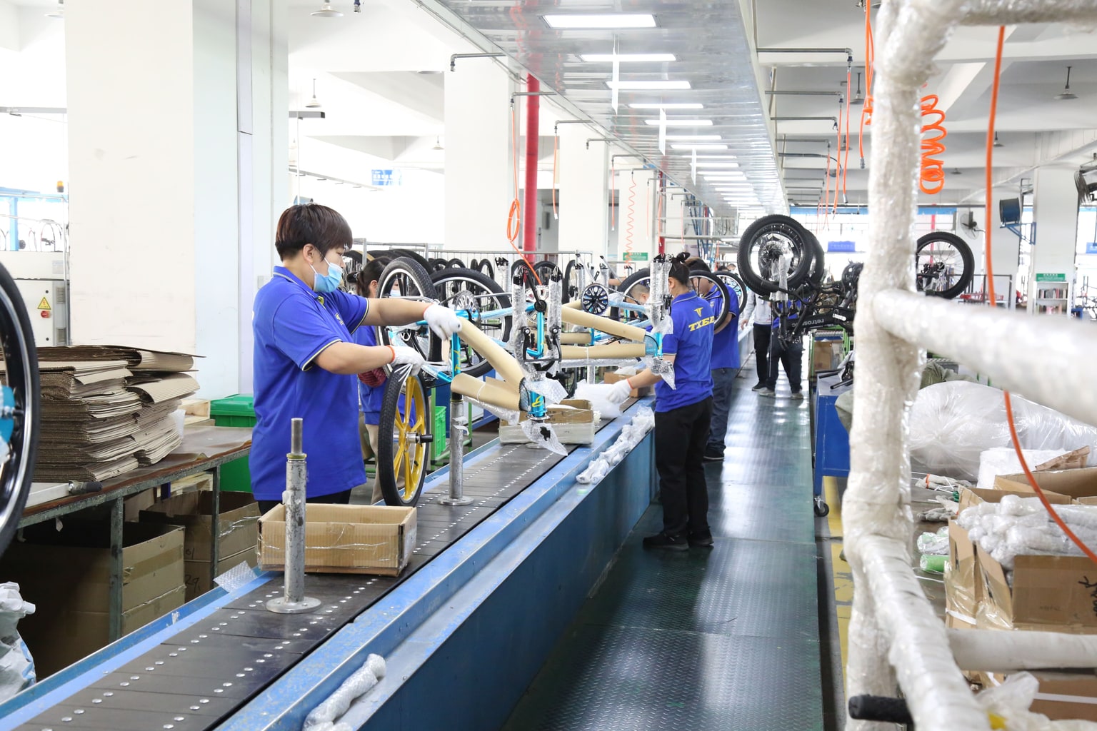 Workers and standardized stations on the TXED electric bike assembly line